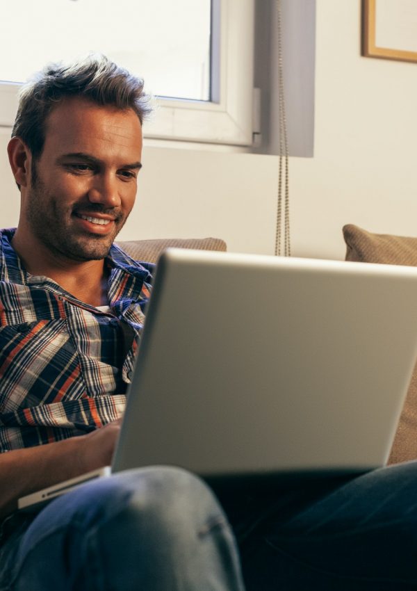 Young Man Using a Laptop at Home
